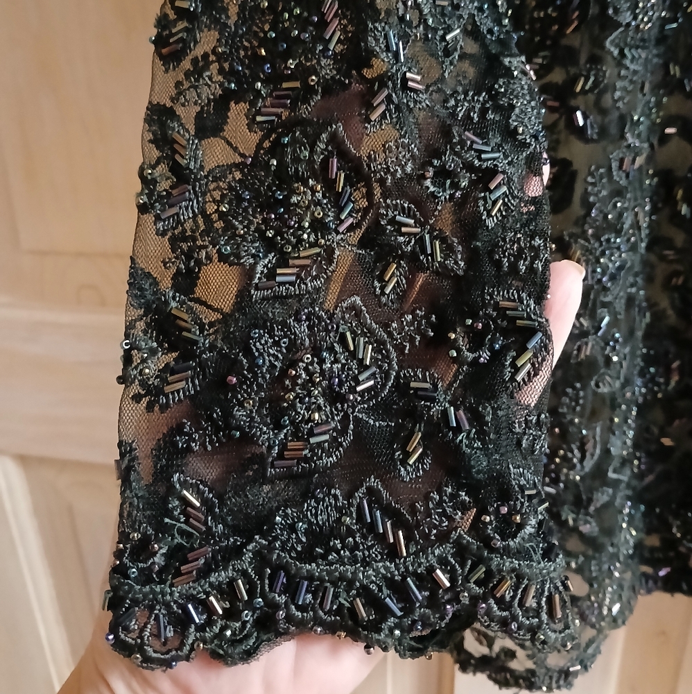 Pant suite black fully  lined.  All beaded.  It was only worn twice.  Like new